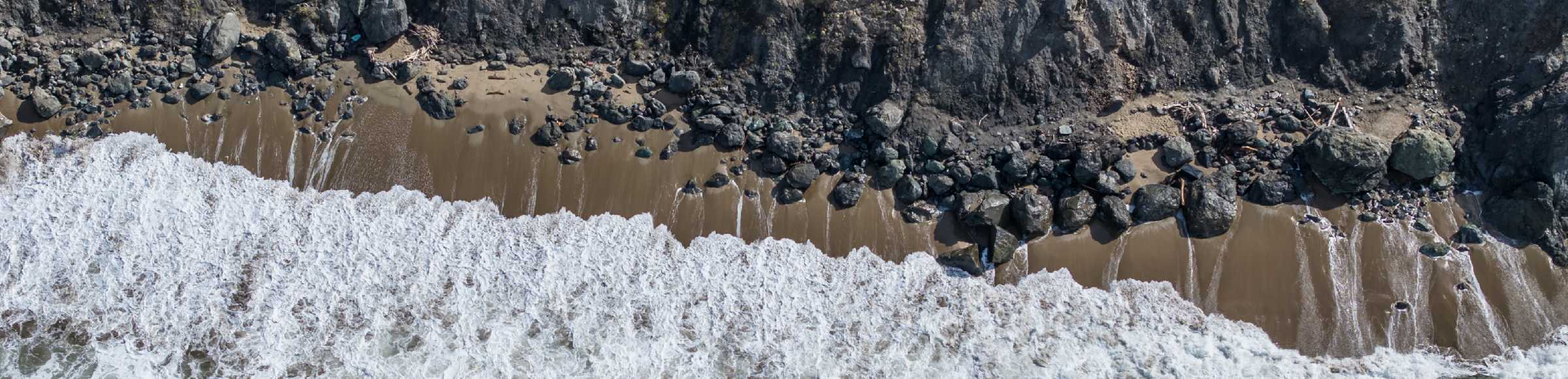 Vertical aerial view from the satellite perspective of the rock Coastline on the cliffs 