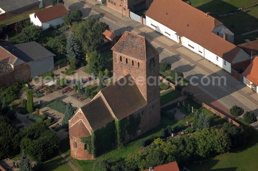 Aerial photograph Melkow - Blick auf die romanische Dorfkirche in Melkow an der Straße der Romanik. Diese Ferienstraße verbindet die Dome, Burgen, Klöster und Kirchen die in der Zeit vom 10. bis Mitte des 13. Jahrhundert entstanden, und somit ein Zeichen der Christianisierung sind. Kontakt: Dorfkirche in Melkow, Dorfstraße, 39524 Melkow-Wust, Deutschland; Tel. +49(39341)406