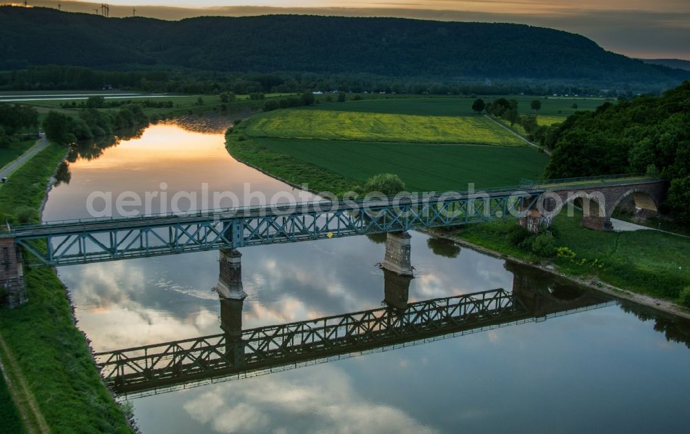 Höxter from above - Viaduct of the railway bridge structure to route the railway tracks crossing the Weser river in Hoexter in the state North Rhine-Westphalia