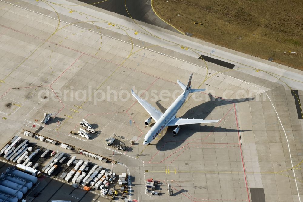 Berlin from the bird's eye view: Dispatch building and terminals on the premises of the airport Tegel Tegel with QATAR cargo plane on the apron in Berlin