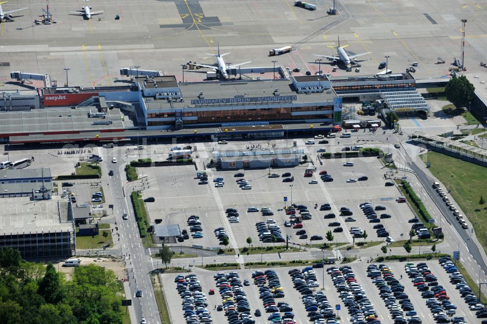 Schönefeld from the bird's eye view: Blick auf die temporär verwaiste Abfertigungshalle am Flughafen Berlin-Schönefeld. Wenn der Flughaffen BBI in absehbarer Zeit in Betrieb gehen wird, dann können solche Bilder für das zum Teil noch aus INTERFLUG-Zeiten stammende Terminal zum Dauerzustand werden. Terminals at the airport Berlin-Schoenefeld.