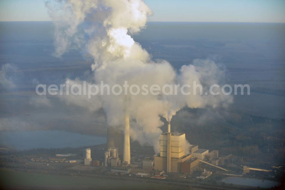 Schöningen from the bird's eye view: Weithin sichtbare Abgas- und Rauchwolken der Türme des Kraftwerk Buschhaus , einem Braunkohlekraftwerk im Helmstedter Revier, nahe der Ortschaft Schöningen. Das Kraftwerk der E.ON Kraftwerke GmbH wurde Ende der 1970er-Jahre geplant. Der neue Kraftwerksbau schuf zusätzliche Arbeitsplätze im Kohlebergbau und in der Verstromung. Das Kraftwerk sollte mit der schwefelhaltigen Salzkohle der Umgebung betrieben werden. Für die benötigte Menge wurde eigens ein neuer Tagebau, der Tagebau Schöningen, aufgefahren. Das Kraftwerk verfügt über einen 307 Meter hohen Schornstein, der der höchste in Betrieb befindliche Industrieschornstein in Deutschland ist. Highly visible exhaust and smoke of the towers of the power plant bush house, a brown coal power plant in the Helmstedt area, near the village of Schöningen.