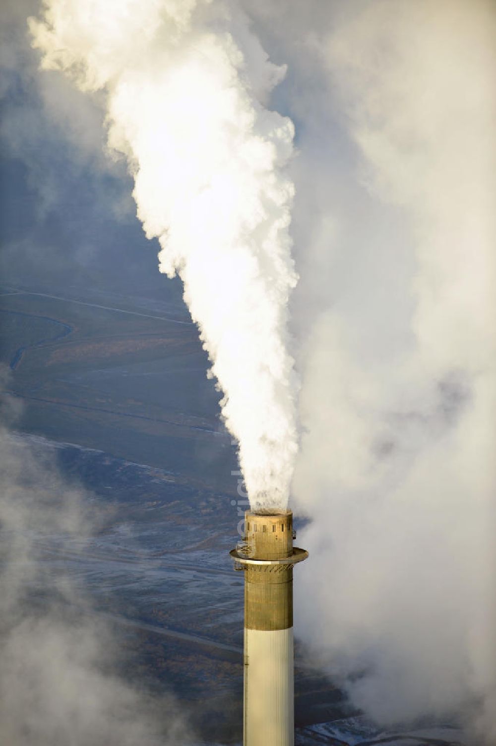 Aerial image Schöningen - Weithin sichtbare Abgas- und Rauchwolken der Türme des Kraftwerk Buschhaus , einem Braunkohlekraftwerk im Helmstedter Revier, nahe der Ortschaft Schöningen. Das Kraftwerk der E.ON Kraftwerke GmbH wurde Ende der 1970er-Jahre geplant. Der neue Kraftwerksbau schuf zusätzliche Arbeitsplätze im Kohlebergbau und in der Verstromung. Das Kraftwerk sollte mit der schwefelhaltigen Salzkohle der Umgebung betrieben werden. Für die benötigte Menge wurde eigens ein neuer Tagebau, der Tagebau Schöningen, aufgefahren. Das Kraftwerk verfügt über einen 307 Meter hohen Schornstein, der der höchste in Betrieb befindliche Industrieschornstein in Deutschland ist. Highly visible exhaust and smoke of the towers of the power plant bush house, a brown coal power plant in the Helmstedt area, near the village of Schöningen.