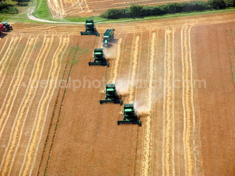 Aerial image Elxleben - Combine harvester farm equipment at harvest on a grain field in Elxleben in Thuringia