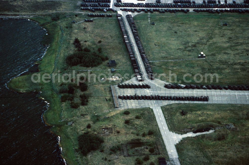 Aerial image Peenemünde - Parked NVA motor vehicle technology of the GDR air force on the runway with taxiway area of the deactivated airfield in Peenemuende on the island of Usedom in the state Mecklenburg-West Pomerania, Germany