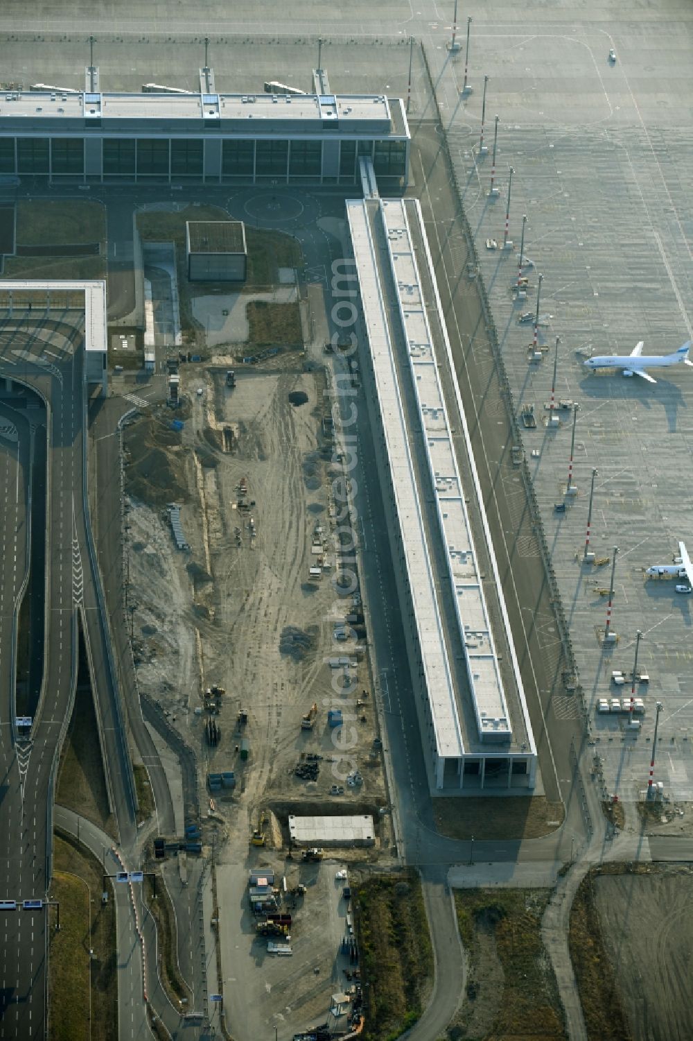 Schönefeld from the bird's eye view: Demolition and unsealing work on the concrete surfaces of Parkflaechen on August-Heinrich-Euler-Strasse on Flughafen BER in Schoenefeld in the state Brandenburg, Germany