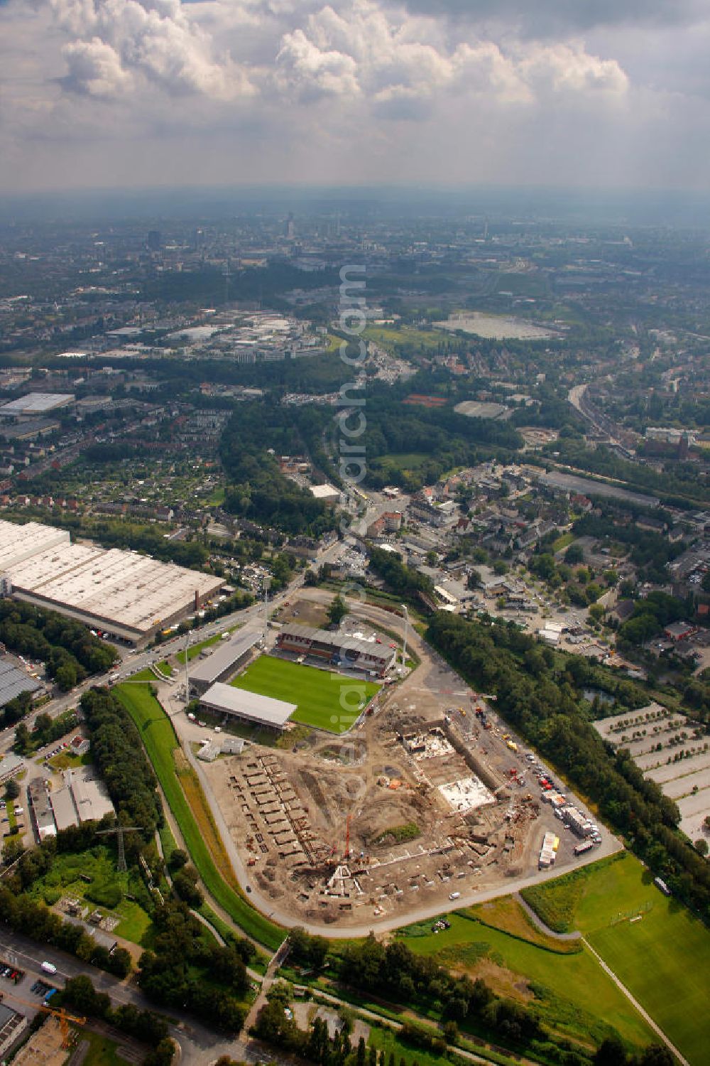 Essen from the bird's eye view: Abrissarbeiten am Georg-Melches-Stadion vom Fußballclub Rot-Weiss Essen in der Stadt Essen, Nordrhein-Westfalen. Gleichzeitig wird ein neues Fußballstadion, welches ca. 20000 Zuschauern Platz bieten soll, leicht versetzt in unmittelbarer Nachbarschaft gebaut. Für die Arbeiten wurde das Bauunternehmen Köster Bau AG beauftragt. Demolition works on the Georg Melches stadium of the soccer club Rot Weiss Essen in Essen, North Rhine-Westphalia. At the same time, a new football stadium is being built in close vicinity to the old stadium. Responsible for the construction work is the building company Koester Bau AG.