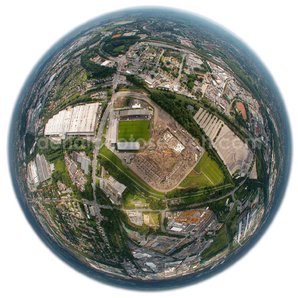 Essen from above - Fish Eye Motiv der Abrissarbeiten am Georg-Melches-Stadion vom Fußballclub Rot-Weiss Essen in der Stadt Essen, Nordrhein-Westfalen. Gleichzeitig wird ein neues Fußballstadion, welches ca. 20000 Zuschauern Platz bieten soll, leicht versetzt in unmittelbarer Nachbarschaft gebaut. Für die Arbeiten wurde das Bauunternehmen Köster Bau AG beauftragt. Demolition works on the Georg Melches stadium of the soccer club Rot Weiss Essen in Essen, North Rhine-Westphalia. At the same time, a new football stadium is being built in close vicinity to the old stadium. Responsible for the construction work is the building company Koester Bau AG.