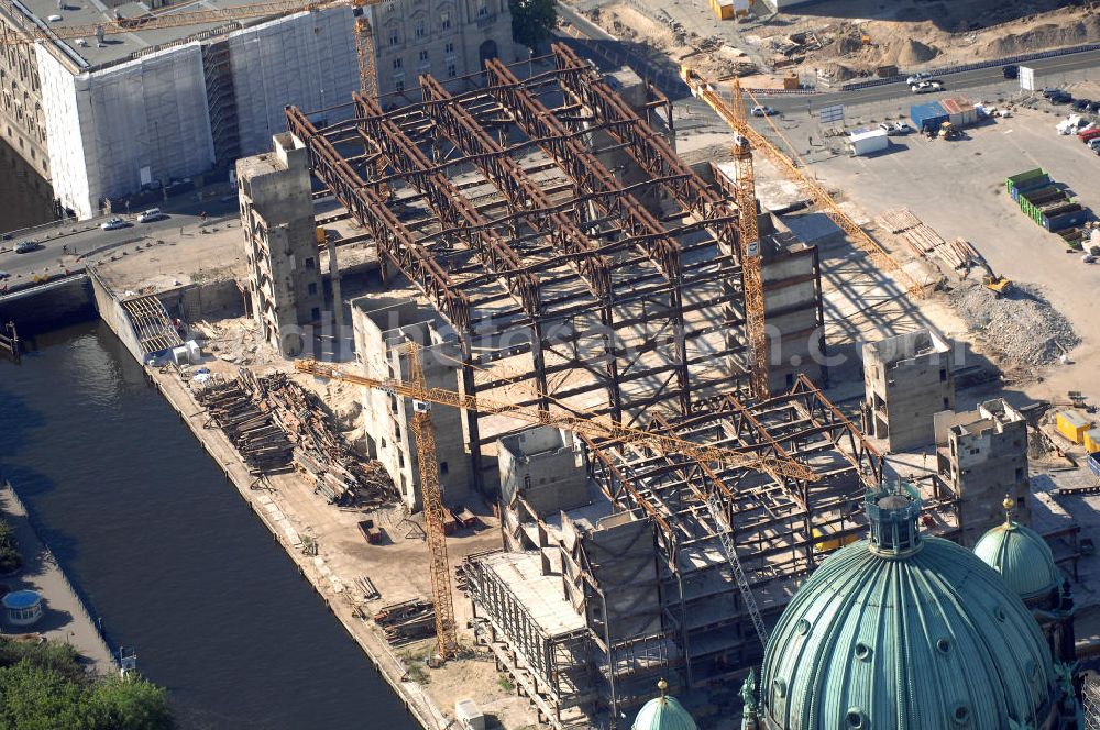 Berlin from above - . Seit Februar 2006 wird der Palast langsam mit Hilfe von fünf Kränen abgerissen. Von einer Sprengung des Gebäudes wurde abgesehen, weil Beschädigungen umliegender Häuser durch den Auftrieb der Bodenwanne und das dadurch bedingte Absinken des Grundwasserspiegels befürchtet wurden. Stattdessen wird das abgetragene Material gemessen und dann im gleichen Maß mit Wasser versetzter Sand in die Bodenwanne geleitet. Die Abrissarbeiten sollten ursprünglich Mitte 2007 abgeschlossen sein. Nachdem im Laufe der Arbeiten an mehreren Stellen neuer Asbest gefunden wurde und sich der Abriss dadurch stark verlangsamte, wird mit Ende 2008 als frühestem Ende kalkuliert. Die Zusatzkosten in Höhe von bislang 9,9 Mio. Euro muss der Bund übernehmen. Nach der vollständigen Abtragung soll vorübergehend eine Grünfläche über der verbleibenden Bodenwanne entstehen.