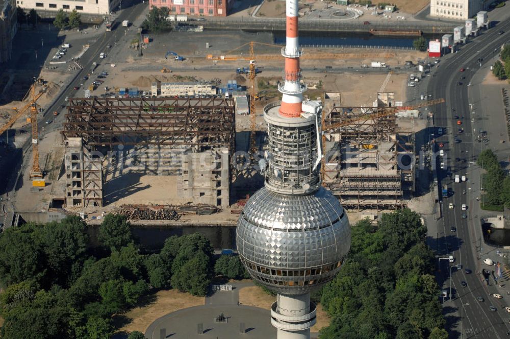 Aerial photograph Berlin - . Seit Februar 2006 wird der Palast langsam mit Hilfe von fünf Kränen abgerissen. Von einer Sprengung des Gebäudes wurde abgesehen, weil Beschädigungen umliegender Häuser durch den Auftrieb der Bodenwanne und das dadurch bedingte Absinken des Grundwasserspiegels befürchtet wurden. Stattdessen wird das abgetragene Material gemessen und dann im gleichen Maß mit Wasser versetzter Sand in die Bodenwanne geleitet. Die Abrissarbeiten sollten ursprünglich Mitte 2007 abgeschlossen sein. Nachdem im Laufe der Arbeiten an mehreren Stellen neuer Asbest gefunden wurde und sich der Abriss dadurch stark verlangsamte, wird mit Ende 2008 als frühestem Ende kalkuliert. Die Zusatzkosten in Höhe von bislang 9,9 Mio. Euro muss der Bund übernehmen. Nach der vollständigen Abtragung soll vorübergehend eine Grünfläche über der verbleibenden Bodenwanne entstehen.