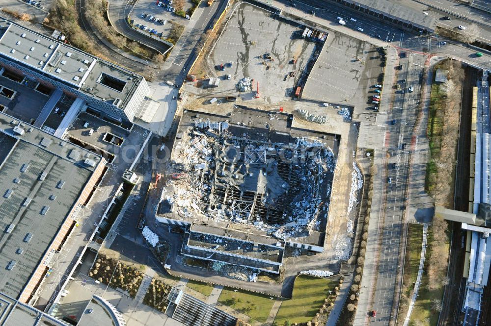 Berlin from the bird's eye view: Blick auf die Abrißarbeiten an der ehemaligen Deutschlandhalle an der Jaffeystraße auf dem Messegelände in Charlottenburg. Abbruch-Bagger der Berliner Firma „ RWG1 “ setzten sie ihre tonnenschweren Kneifzangen in Betrieb und hackten sich in den Beton. Begonnen wurde mit dem Fassaden-Abriss an der Nordseite der Halle mit Abbruch-Bagger der Marke „ Liebherr “, Modelle 954 und 974. Sie wiegen 87 bis 140 Tonnen, haben bis zu 543 PS, nehmen die Fassade mit verschiedenen Greif- und Kneifbacken in die Zange. Der Abbruch soll bis März des Folgejahres beendet sein, um die nötige Baufreiheit für die Grundsteinlegung einer neuen Kongress- und Messehalle der Messe Berlin zu gewährleisten. Demolition work of the former Germany Halle Jaffeystraße on the fairgrounds in Charlottenburg.