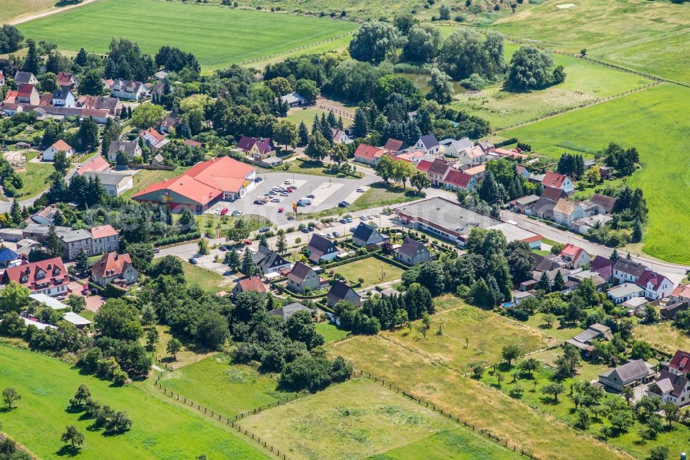 Niemegk from the bird's eye view: Parking space for parked cars at the shopping center Nahkauf and Netto in Niemegk in the state Brandenburg, Germany