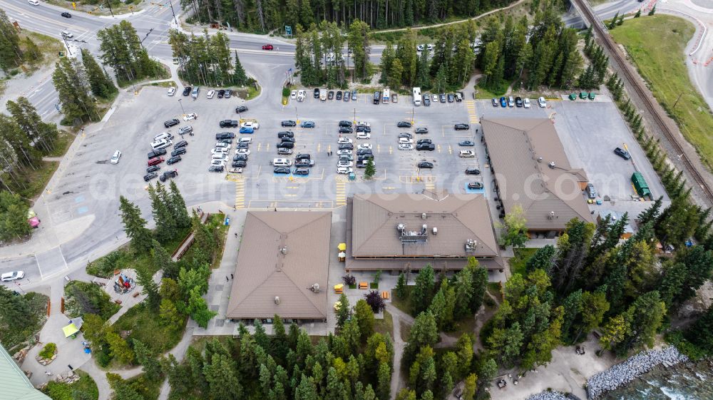 Aerial image Lake Louise - Parking space for parked cars at the shopping center The Village Market on street Lake Louise Drive in Lake Louise in Alberta, Canada