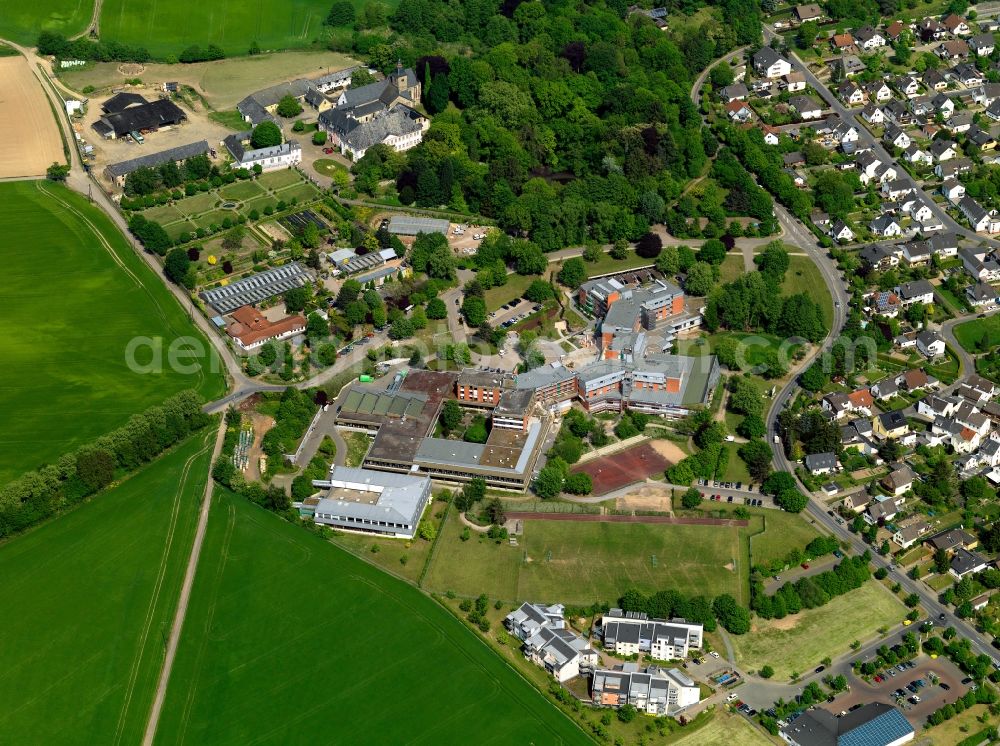 Neuwied from above - Rommersdorf Abbey in the Heimbach-Weis part of the town of Neuwied in the state of Rhineland-Palatinate. The town is located in the county district of Mayen-Koblenz on the right riverbank of the river Rhine. The town is an official tourist resort and is an important historic industrial site. Heimbach-Weis is located in its North. The abbey with its cross-coat is a landmark of the town and event location of the open air festival