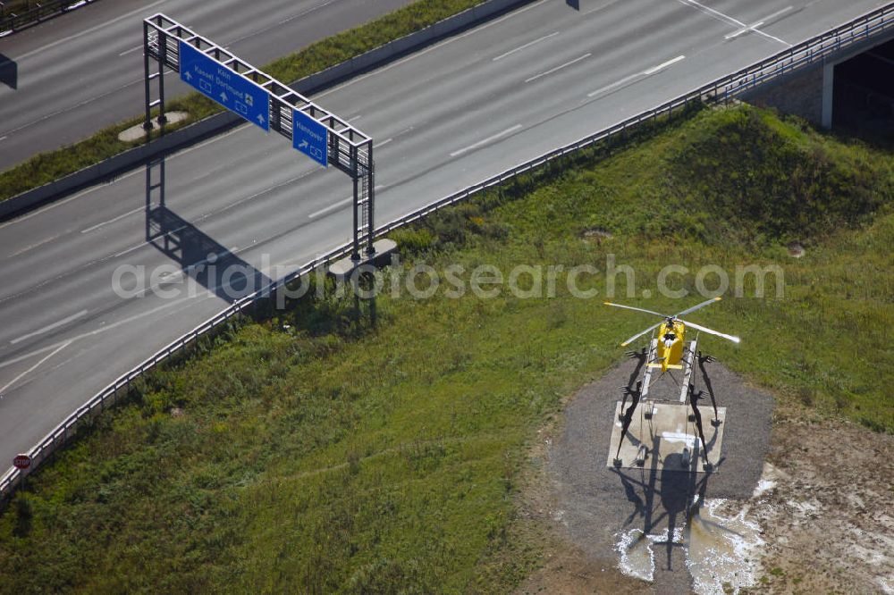 Aerial image Kamen - Blick auf das Autobahnkreuz Kamener Kreuz im Nordosten des Ruhrgebietes bei Kamen. Neu installiert ist das ADAC-Denkmal , einer Skluptur aus acht Figuren , welche einen ausrangierten ADAC- Helikopter tragen. Die Kunstinstallation Gelbe Engel ist ein Werk des Kuenstler Alex Gockel. Rund 200.000 Fahrzeuge passieren täglich das Kreuz und somit hat dieses kunstwerk reale Chancen, zum meistbeachteten Kunstwerk Deutschlands zu werden.