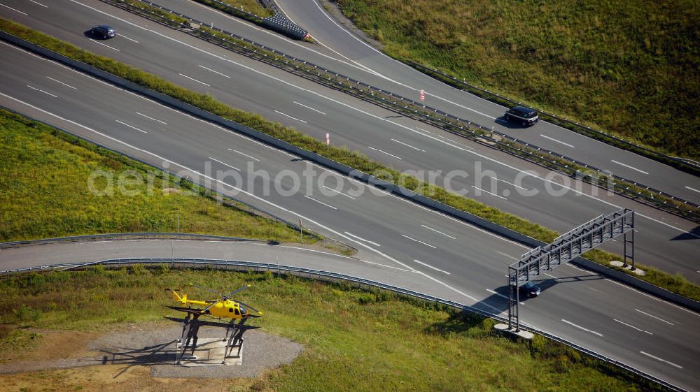 Aerial image Kamen - Blick auf das Autobahnkreuz Kamener Kreuz im Nordosten des Ruhrgebietes bei Kamen. Neu installiert ist das ADAC-Denkmal , einer Skluptur aus acht Figuren , welche einen ausrangierten ADAC- Helikopter tragen. Die Kunstinstallation Gelbe Engel ist ein Werk des Kuenstler Alex Gockel. Rund 200.000 Fahrzeuge passieren täglich das Kreuz und somit hat dieses kunstwerk reale Chancen, zum meistbeachteten Kunstwerk Deutschlands zu werden.