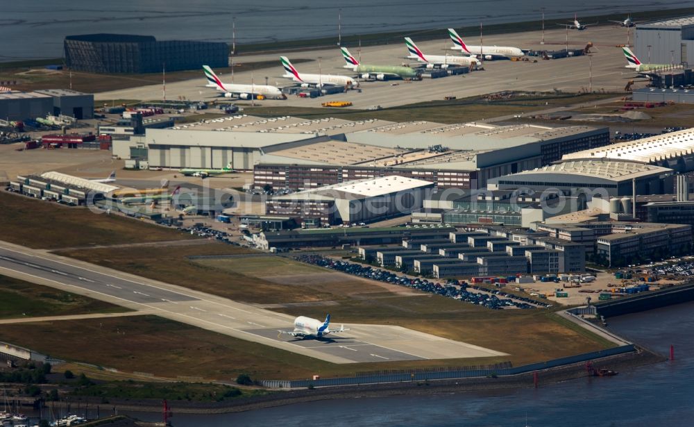 Hamburg from above - Airbus works and airport of Finkenwerder in Hamburg in Germany. The former Hamburger Flugzeugbau works - on the Finkenwerder Peninsula on the riverbank of the Elbe - include an Airbus production site with an airplane. Several Airbus planes and models are being constructed here