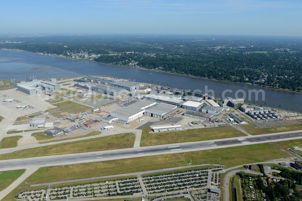 Hamburg from above - Airbus works and airport of Finkenwerder in Hamburg in Germany. The former Hamburger Flugzeugbau works - on the Finkenwerder Peninsula on the riverbank of the Elbe - include an Airbus production site with an airplane. Several Airbus planes and models are being constructed here