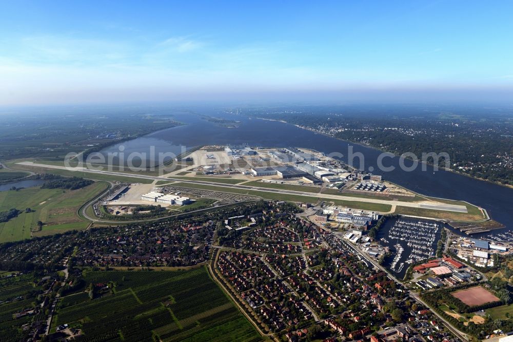 Hamburg from the bird's eye view: Airbus works and airport of Finkenwerder in Hamburg in Germany. The former Hamburger Flugzeugbau works - on the Finkenwerder Peninsula on the riverbank of the Elbe - include an Airbus production site with an airplane. Several Airbus planes and models are being constructed here