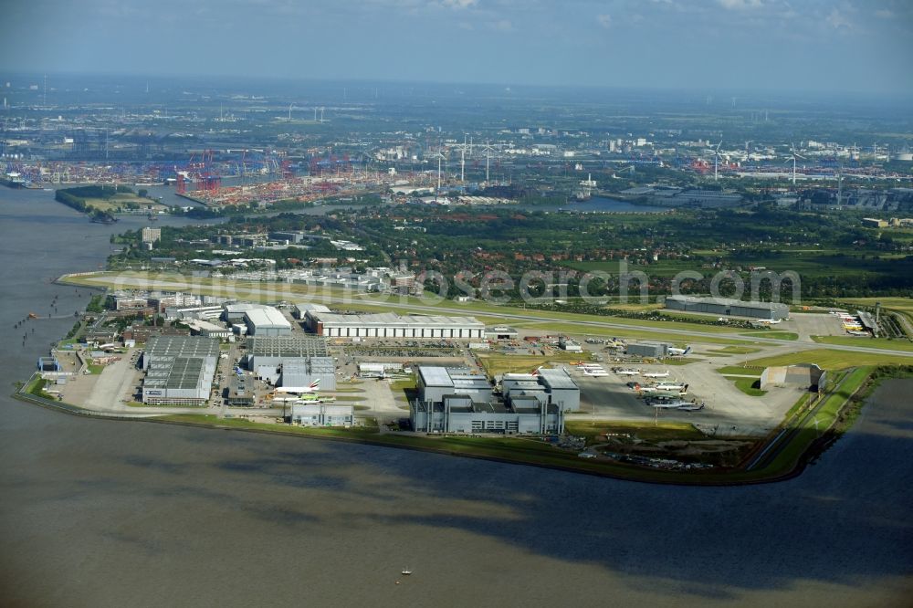 Hamburg from above - Airbus works and airport of Finkenwerder in Hamburg in Germany. The former Hamburger Flugzeugbau works - on the Finkenwerder Peninsula on the riverbank of the Elbe - include an Airbus production site with an airplane. Several Airbus planes and models are being constructed here