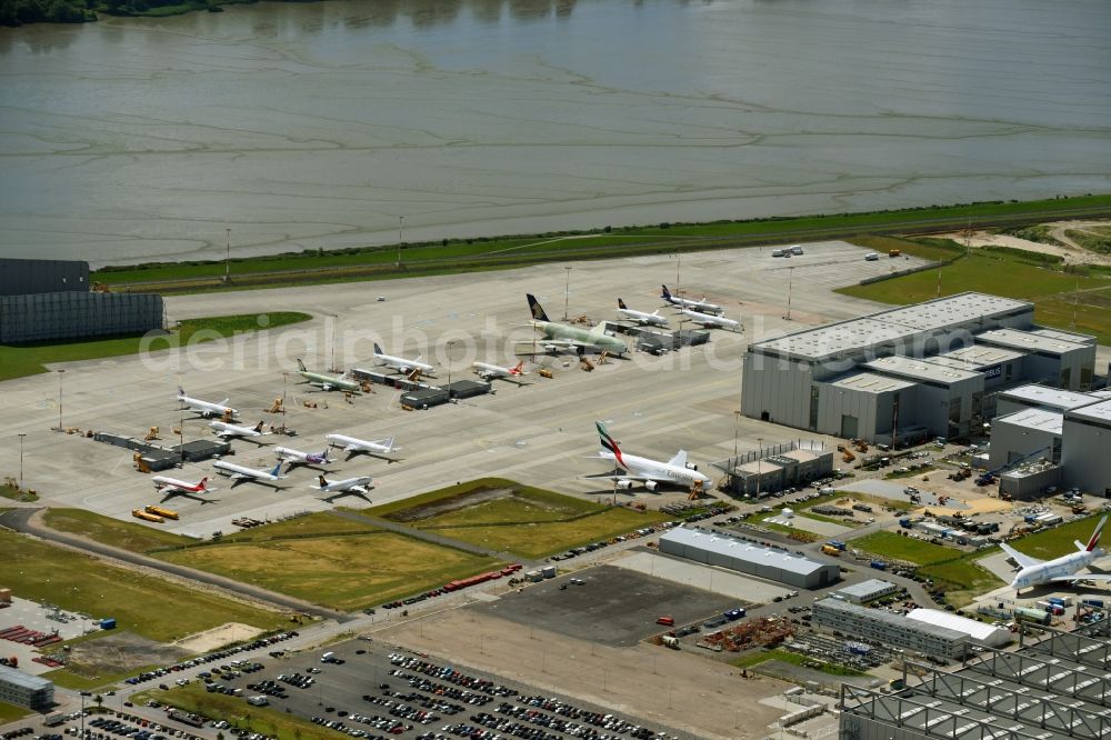 Hamburg from above - Airbus works and airport of Finkenwerder in Hamburg in Germany. The former Hamburger Flugzeugbau works - on the Finkenwerder Peninsula on the riverbank of the Elbe - include an Airbus production site with an airplane. Several Airbus planes and models are being constructed here