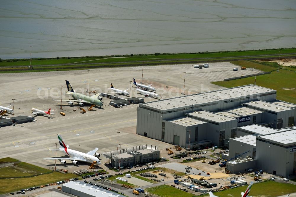 Hamburg from the bird's eye view: Airbus works and airport of Finkenwerder in Hamburg in Germany. The former Hamburger Flugzeugbau works - on the Finkenwerder Peninsula on the riverbank of the Elbe - include an Airbus production site with an airplane. Several Airbus planes and models are being constructed here