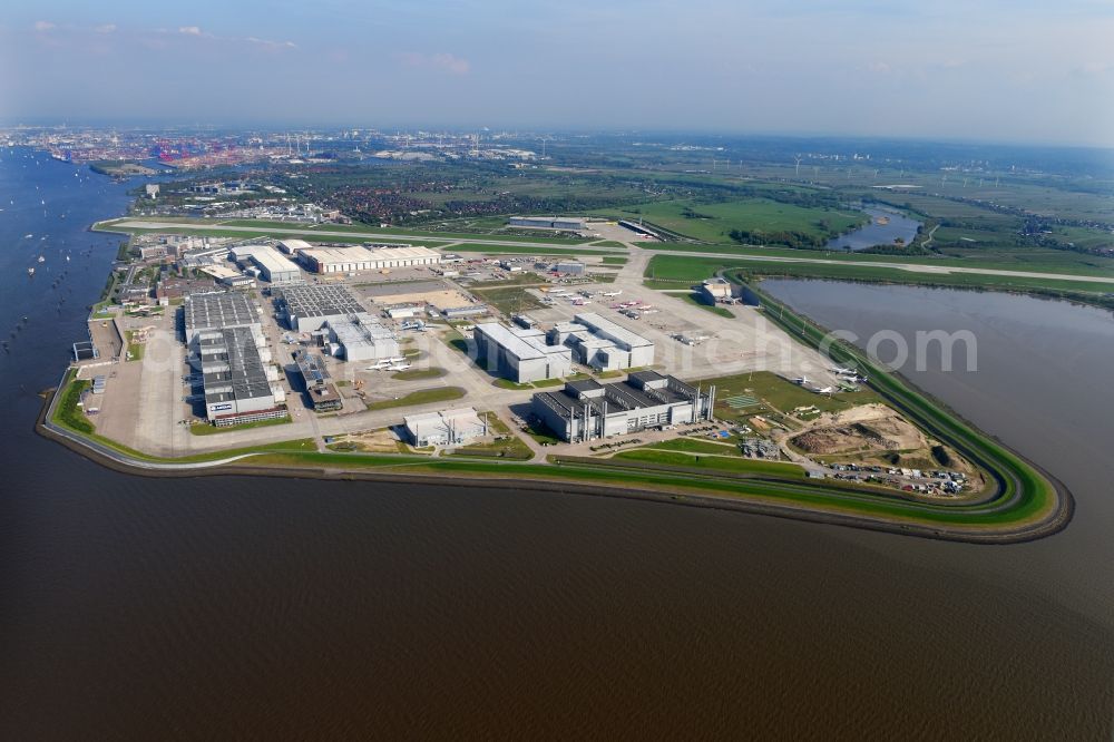 Aerial photograph Hamburg - Airbus works and airport of Finkenwerder in Hamburg in Germany. The former Hamburger Flugzeugbau works - on the Finkenwerder Peninsula on the riverbank of the Elbe - include an Airbus production site with an airplane. Several Airbus planes and models are being constructed here