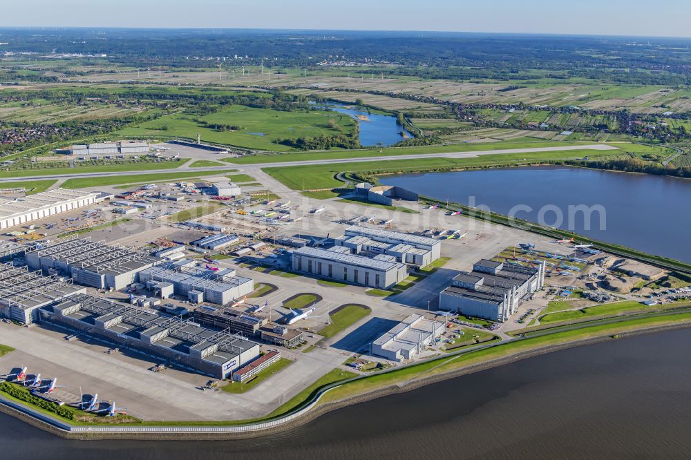 Aerial image Hamburg - Airbus works and airport of Finkenwerder in Hamburg in Germany. The former Hamburger Flugzeugbau works - on the Finkenwerder Peninsula on the riverbank of the Elbe - include an Airbus production site with an airplane. Several Airbus planes and models are being constructed here