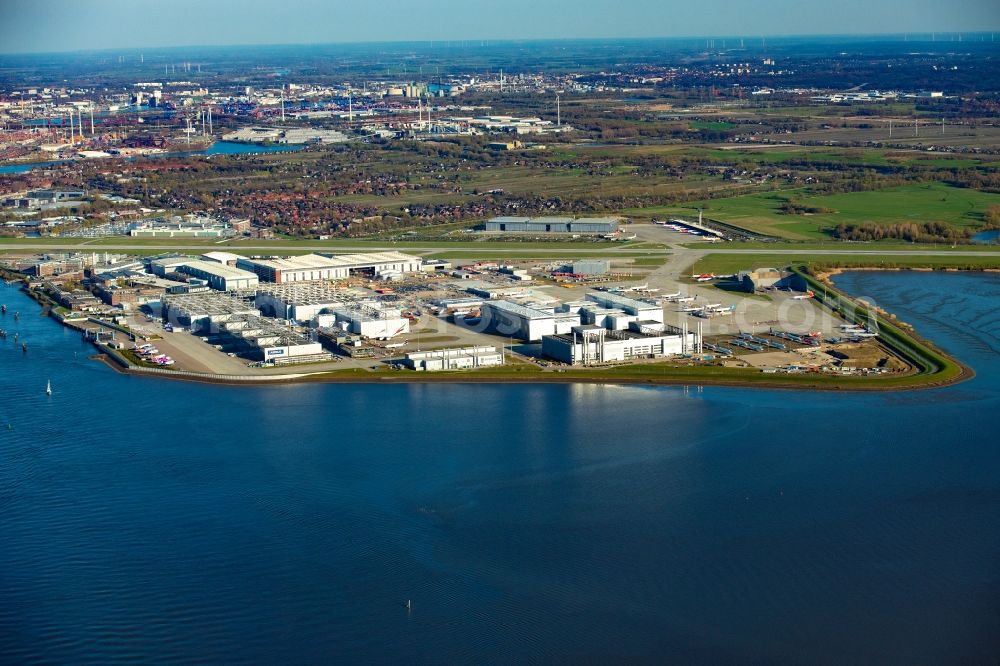 Hamburg from above - Airbus works and airport of Finkenwerder in Hamburg in Germany. The former Hamburger Flugzeugbau works - on the Finkenwerder Peninsula on the riverbank of the Elbe - include an Airbus production site with an airplane. Several Airbus planes and models are being constructed here