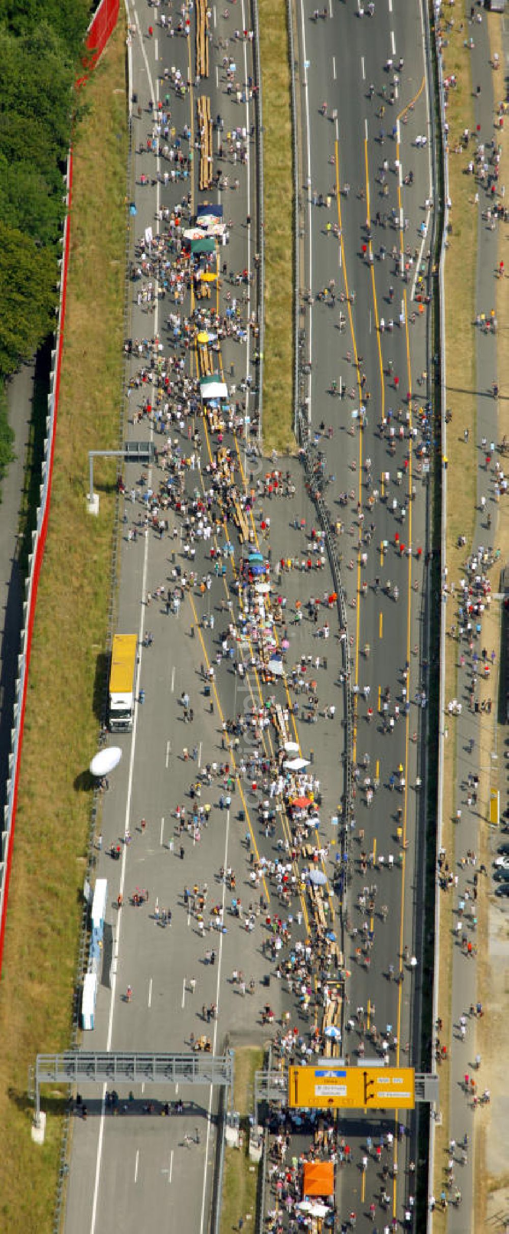 Dortmund from the bird's eye view: Blick auf die Autobahn an der Schnettkerbrücke über Besucher der Aktion auf der A40 bei Dortmund. Der Autobahnbereich ist komplett gesperrt für die Aktion „ Still-Leben “ der Kulturhauptstadt RUHR 2010 statt. Auf einer Strecke von fast 60 Kilometern bilden 20.000 Tische die nach Angaben der Veranstalter laengste Tafel der Welt. Visitors to the campaign at the highway A40 in Dortmund. The highway section is completely closed to the action Still-life of the Ruhr Culture 2010. On a stretch of nearly 60 kilometers form the longest 20 000 tables, according to the organizer panel in the world.