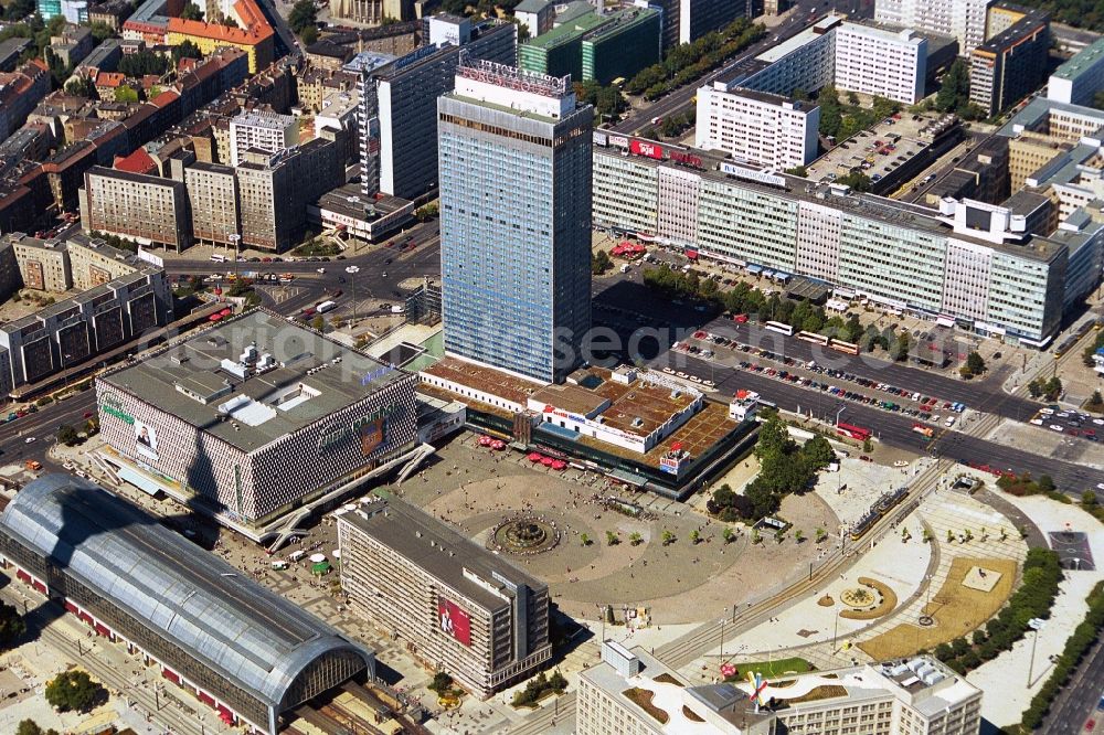 Aerial image Berlin - The Alexanderplatz in Berlin-Mitte end of 1990 years with the S-Bahn station, the department store Galeria Kaufhof and the Forum Hotel. Even the appearance corresponds to the development plans of the communist era. The Forum hotel was designed by the renowned architect Roland Korn and Hans Erich Bogatzky