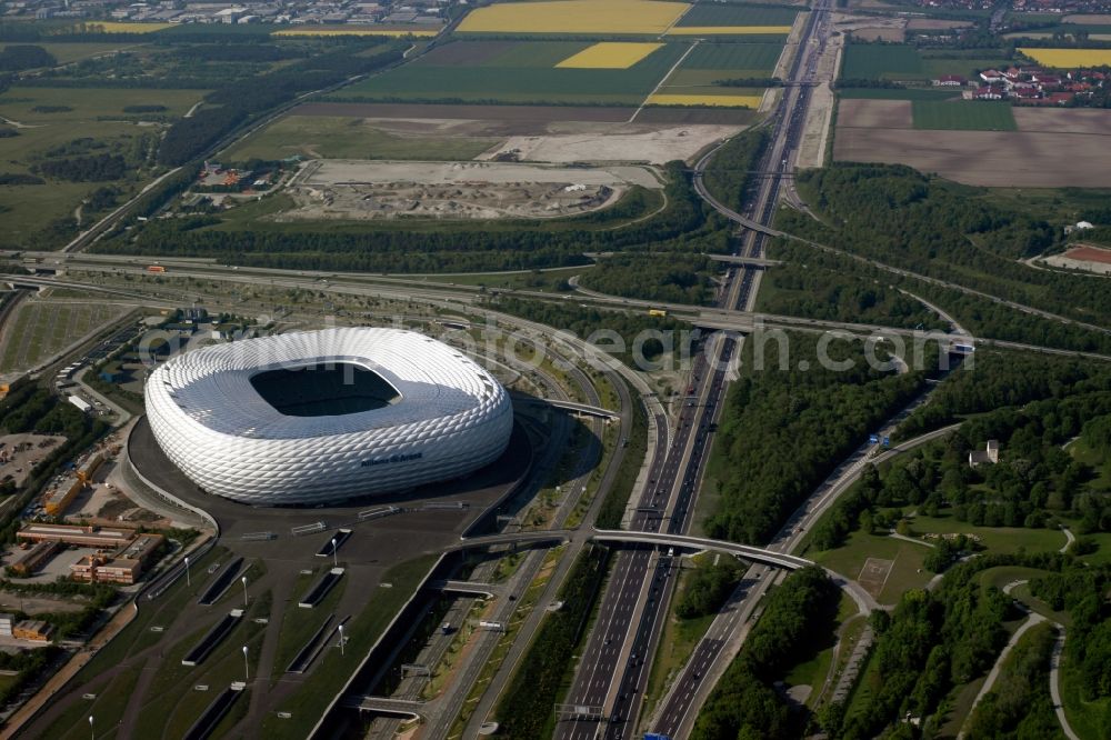 München from the bird's eye view: The Allianz Arena in Munich in Bavaria is a football stadium of the the Munich football club FC Bayern Muenchen. The facade of the, designed by the architects Herzog & de Meuron stadium Allianz Arena Muenchen Stadion GmbH consists of illuminated white foil cushions