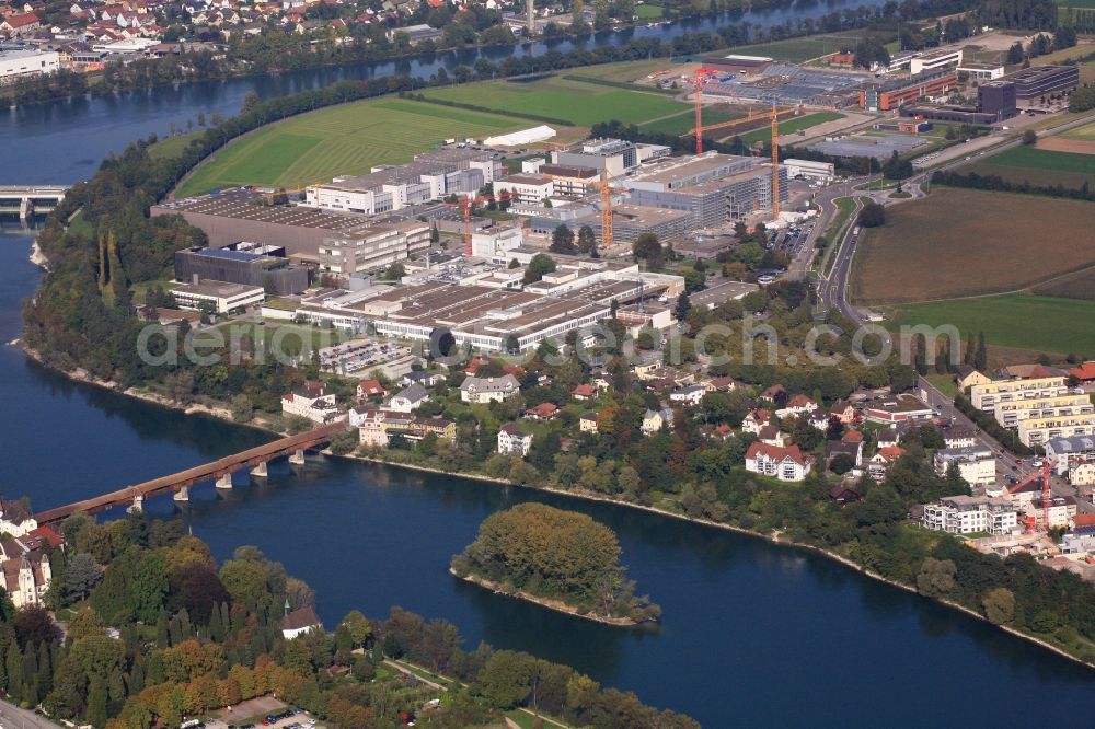 Bad Säckingen from above - Fridolin island and wooden bridge over the Rhine at Bad Saeckingen in the state of Baden-Wuerttemberg. On the opposite side of the river the premises of pharmaceutical company Novartis in Stein in Switzerland