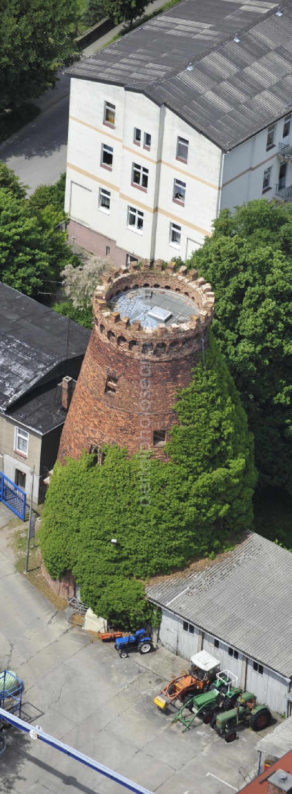 Genthin from above - Blick auf den zugewachsenen Turm einer alten Windmühle an der Fabrikstraße in Genthin. View of the overgrown tower of an old windmill on the factory street Genthin.