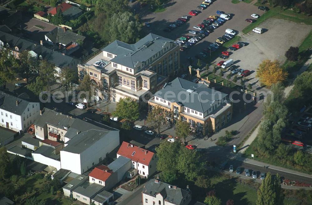 Werder ( Brandenburg ) from the bird's eye view: Das »Alte Brauhaus Werder« wurde 1887 erbaut und steht unter Denkmalschutz. 1995 wurde es aufgestockt und um einen Anbau erweitert. Beide Bauteile bilden ein Ensemble, das sich an der Hauptgeschäftsstraße befindet und in der Innenstadt von Werder einen architektonischen Schwerpunkt bildet. HVB Immobilien AG Der Standort unmittelbar am Ufer der Havel und kurz vor der Brücke in die historische Altstadt gehört zu den exponierten Lagen vor Ort.