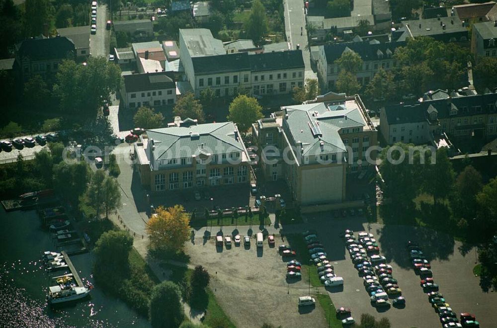 Werder ( Brandenburg ) from the bird's eye view: Das »Alte Brauhaus Werder« wurde 1887 erbaut und steht unter Denkmalschutz. 1995 wurde es aufgestockt und um einen Anbau erweitert. Beide Bauteile bilden ein Ensemble, das sich an der Hauptgeschäftsstraße befindet und in der Innenstadt von Werder einen architektonischen Schwerpunkt bildet. HVB Immobilien AG Der Standort unmittelbar am Ufer der Havel und kurz vor der Brücke in die historische Altstadt gehört zu den exponierten Lagen vor Ort.