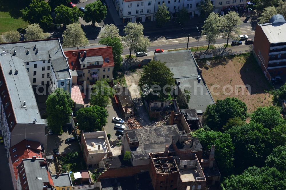 Aerial photograph Magdeburg - Old factory in a residential area on Luebecker Street in Magdeburg in the state Saxony-Anhalt. The partly ruined and destructed building with chimneys and funnels is located between newer multi family buildings and apartment buildings