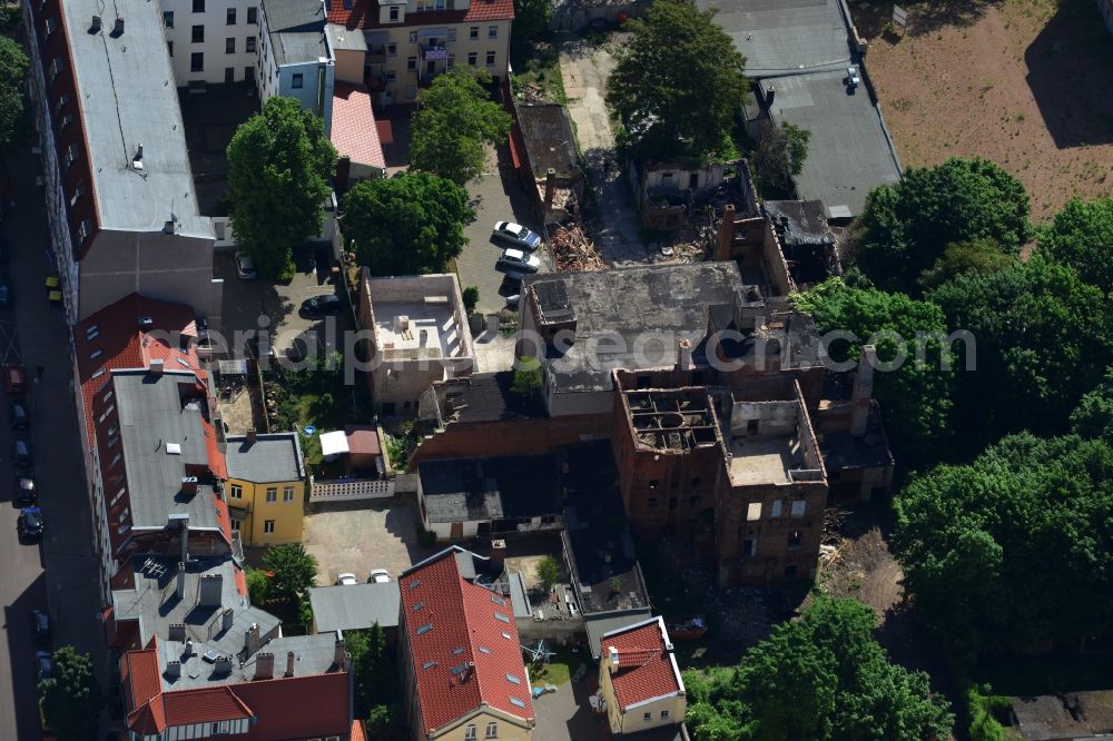 Magdeburg from above - Old factory in a residential area on Luebecker Street in Magdeburg in the state Saxony-Anhalt. The partly ruined and destructed building with chimneys and funnels is located between newer multi family buildings and apartment buildings