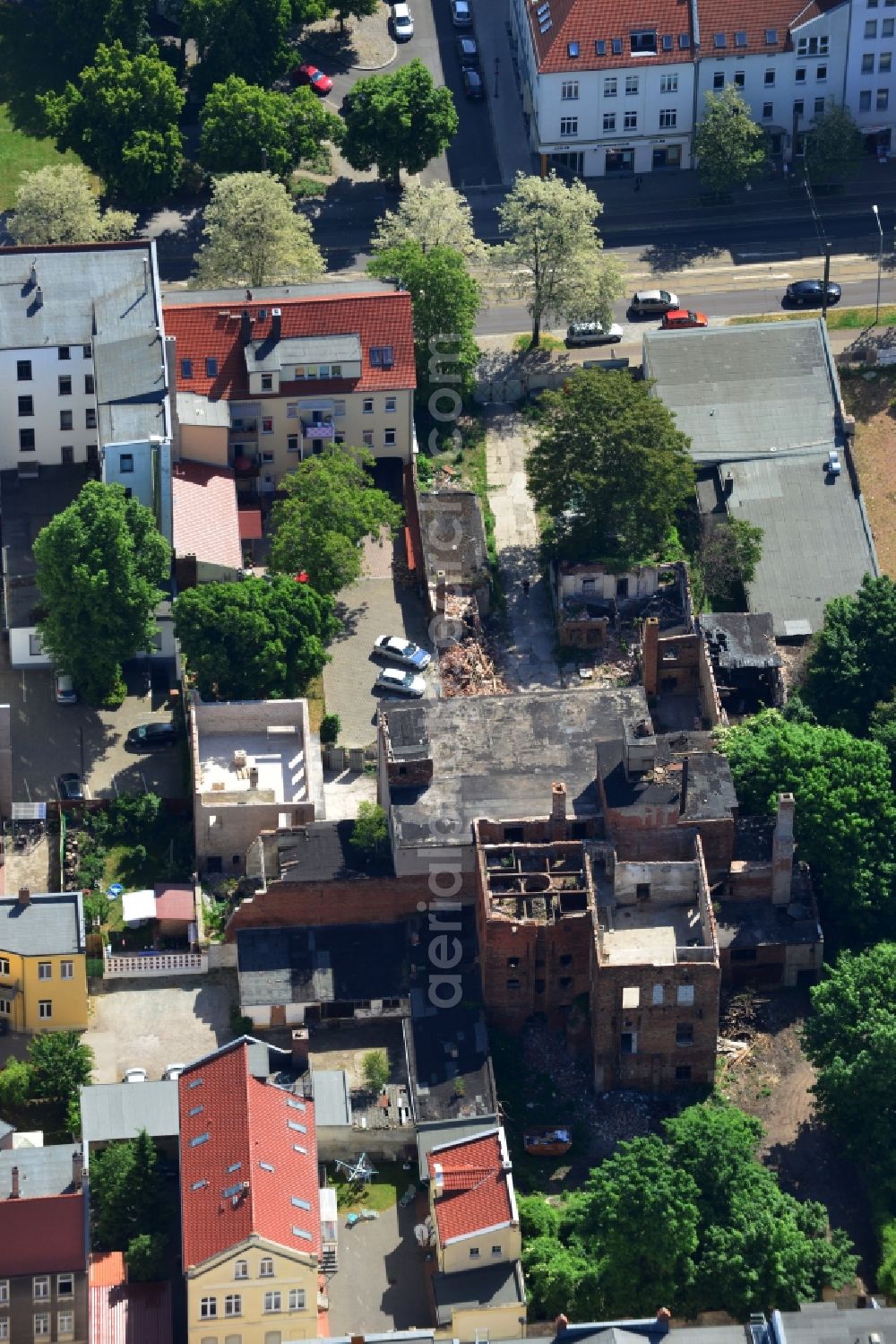 Magdeburg from the bird's eye view: Old factory in a residential area on Luebecker Street in Magdeburg in the state Saxony-Anhalt. The partly ruined and destructed building with chimneys and funnels is located between newer multi family buildings and apartment buildings