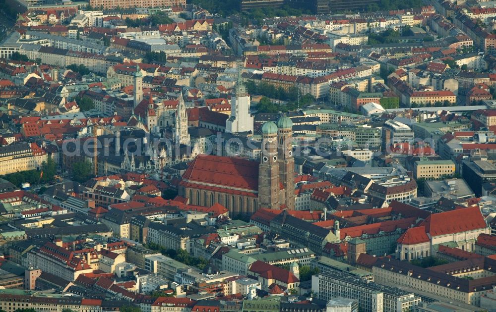 München from above - In the old city of Munich in Bavaria dominate attractions such as the Frauenkirche, the New Town Hall, Old Town Hall, St. Peter's Church and the Holy Spirit Church of the cityscape. The Frauenkirche is a late Gothic brick building. The church with its two distinctive towers is the symbol of the state capital of Bavaria. At the time of receiving the tower of St. Peter's had scaffolding. The New Town Hall in Munich enjoys a filigree design elements in the Gothic Revival style