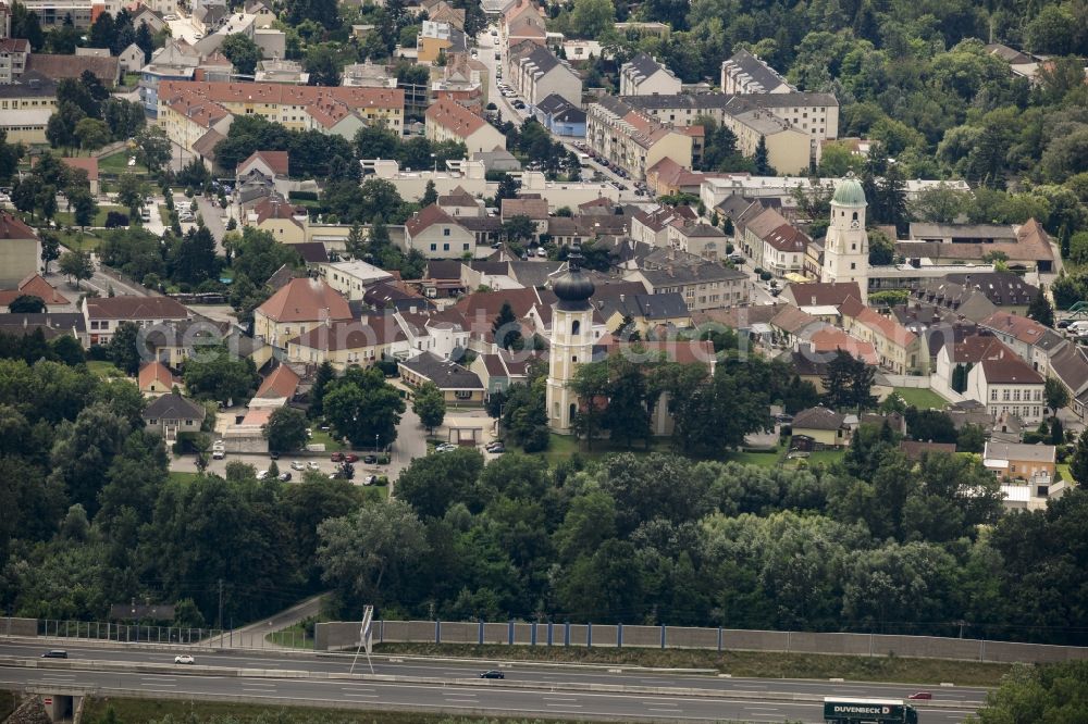 Aerial image Fischamend - Historical town center of Fischamend adjacent to the federal motorway A4 in Lower Austria, Austria. The town center includes the church of Fischamend-Markt and the old Market Tower