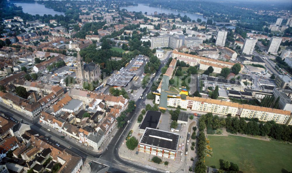 Aerial photograph Potsdam - Blick auf eine Antonow AN-2 der Interflug Air Touristik über Potsdams historische Innenstadt. Unter dem Doppeldecker Typ STOL-Mehrzweckflugzeug erstrecken sich Wohngebäude, die katholischen Propsteikirche St. Peter und Paul, der Bassinplatz mit Busbahnhof, der Platz der Einheit und das Klinikum Ernst von Bergmann. View of an Antonov AN-2 of the Interflug Air Touristik above Potsdam's historical city center with residential buildings, the Catholic Deanery Church of St. Peter and Paul, the place of unity and the clinical center Ernst von Bergmann.