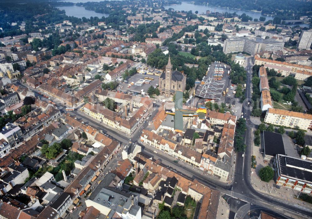 Potsdam from above - Blick auf eine Antonow AN-2 der Interflug Air Touristik über Potsdams historische Innenstadt. Unter dem Doppeldecker Typ STOL-Mehrzweckflugzeug erstrecken sich Wohngebäude, die katholischen Propsteikirche St. Peter und Paul, der Bassinplatz mit Busbahnhof, der Platz der Einheit und das Klinikum Ernst von Bergmann. View of an Antonov AN-2 of the Interflug Air Touristik above Potsdam's historical city center with residential buildings, the Catholic Deanery Church of St. Peter and Paul, the place of unity and the clinical center Ernst von Bergmann.