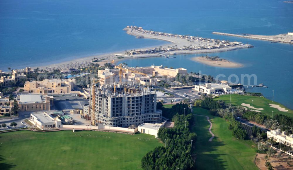 Ras Al Khaimah from above - Complex and construction site of the Al Hamra Fort Hotel & Beach Resort in the arab emirate Ras Al Khaimah. The complex is part of the construction project Al Hamra Village which is realized by the state-owned company Al Hamra Real Estate