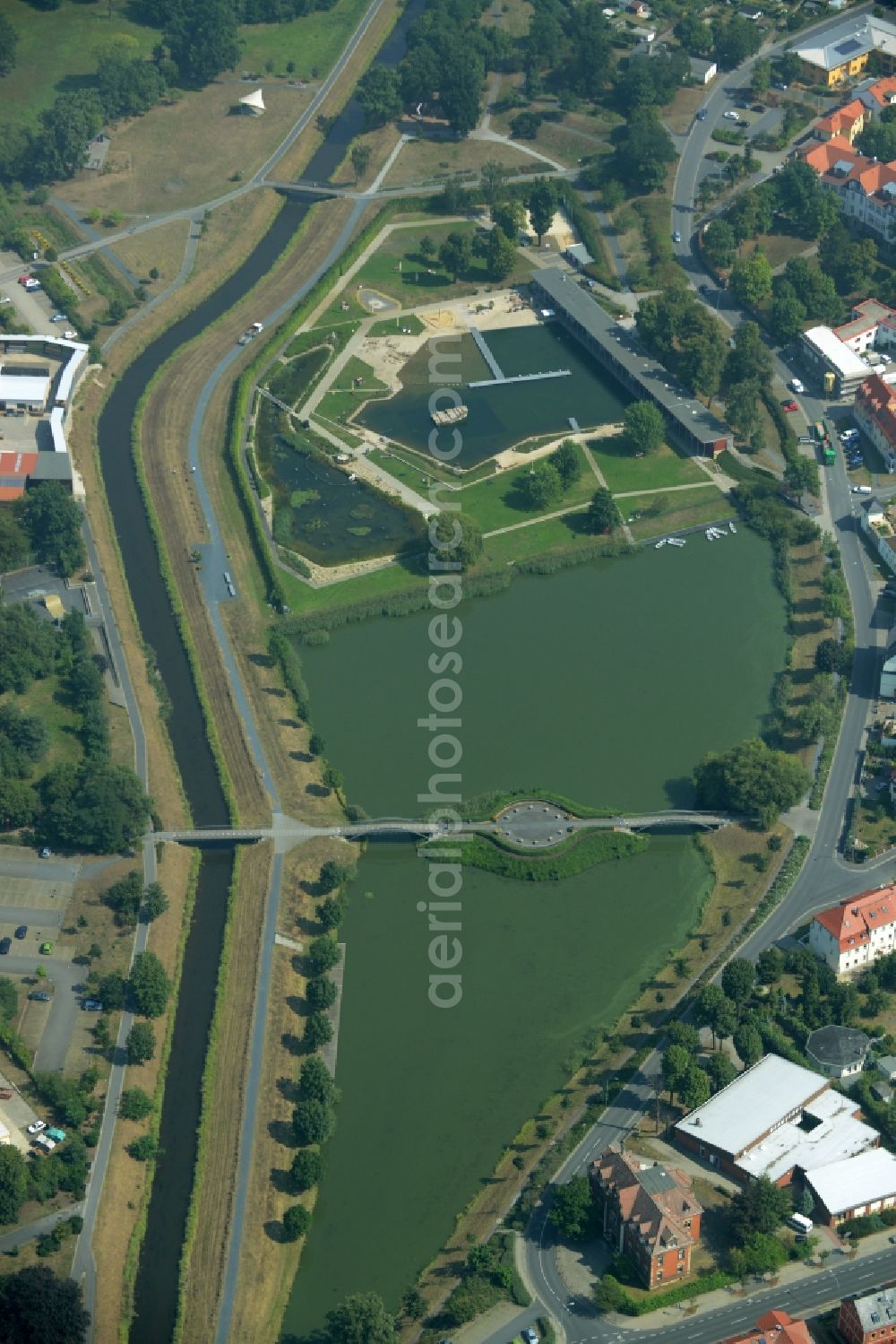 Aerial photograph Großenhain - Nature outdoor pool in Grossenhain in the state of Saxony. The facilities include several buildings as well as a lake compound and bridges. The pool borders the canal of Roederneugraben