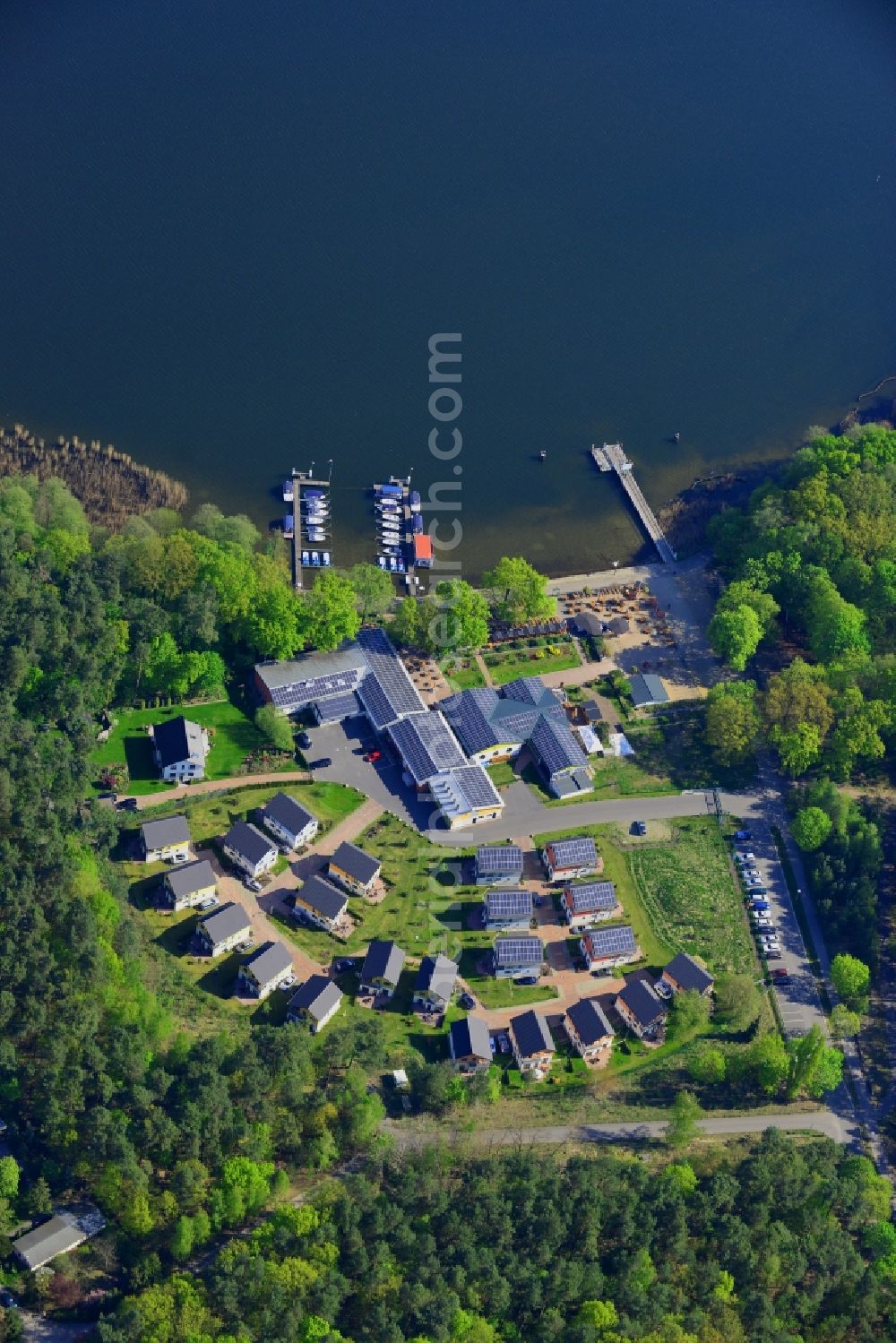 Aerial image Berlin - Complex of the Ruebezahl on the shores of the Mueggelsee in Berlin in Germany. The compound includes a restaurant, a boat renting place and a holiday house complex and is located on the shores of the lake in the nature protection area of Koepenick