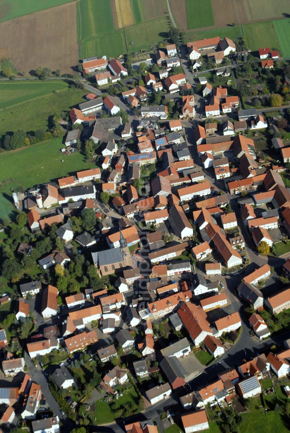 Willingshausen-Wasenberg from the bird's eye view: Blick auf die ev.-ref. Kirchengemeinde Wasenberg. Sie hat knapp 1400 Mitglieder. Das Wahrzeichen des Dorfes ist die mit ihrem 47 Meter hohen Turm weithin sichtbare Kirche, die 1857 von dem namhaften Architekten Ungewitter im neugotischen Stil erbaut wurde.