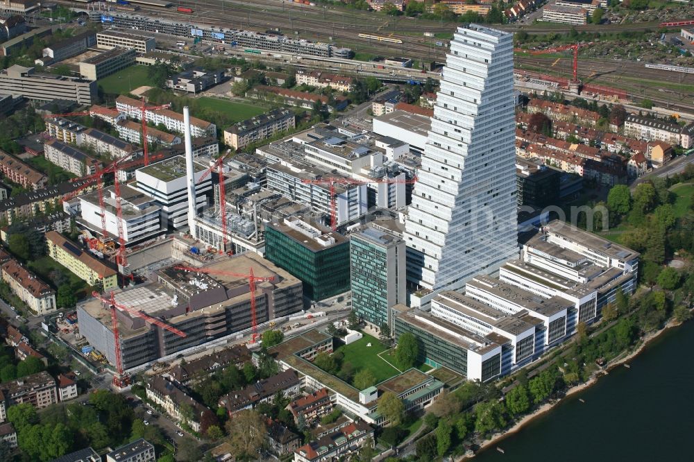 Basel from the bird's eye view: Factory premises of the pharmaceutical Company Roche with the landmark building and skyscraper in Basel in Switzerland