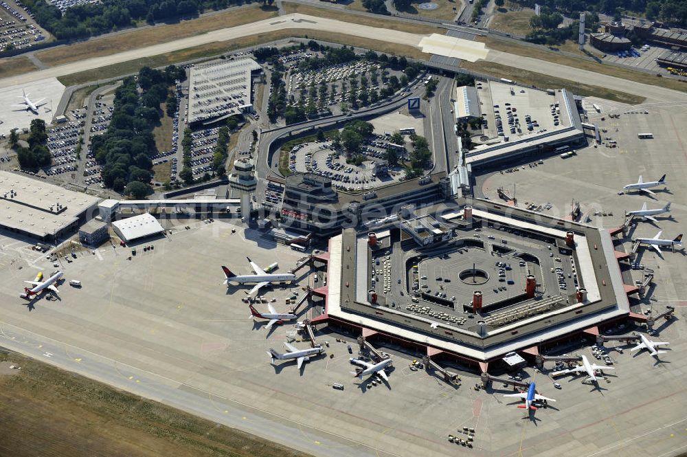 Berlin from above - Blick auf das Areal des Flughafen Berlin- Tegel mit den beiden Start- und Landebahnen. Am Abfertigungsterminal stehen Flugzeuge der DELTA , AIR Berlin und BRITISH AIRWAYS. View of the area of the airport Berlin-Tegel with the two runways. On the Terminal stand aircraft - operated by DELTA, AIR BERLIN and BRITISH AIRWAYS.