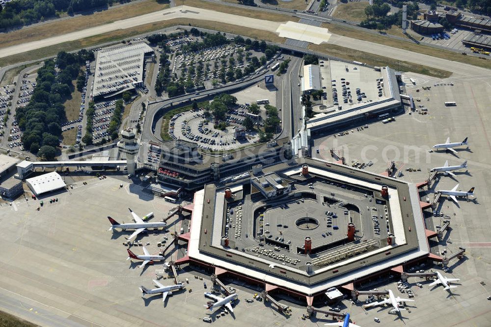 Berlin from above - Blick auf das Areal des Flughafen Berlin- Tegel mit den beiden Start- und Landebahnen. Am Abfertigungsterminal stehen Flugzeuge der DELTA , AIR Berlin und BRITISH AIRWAYS. View of the area of the airport Berlin-Tegel with the two runways. On the Terminal stand aircraft - operated by DELTA, AIR BERLIN and BRITISH AIRWAYS.